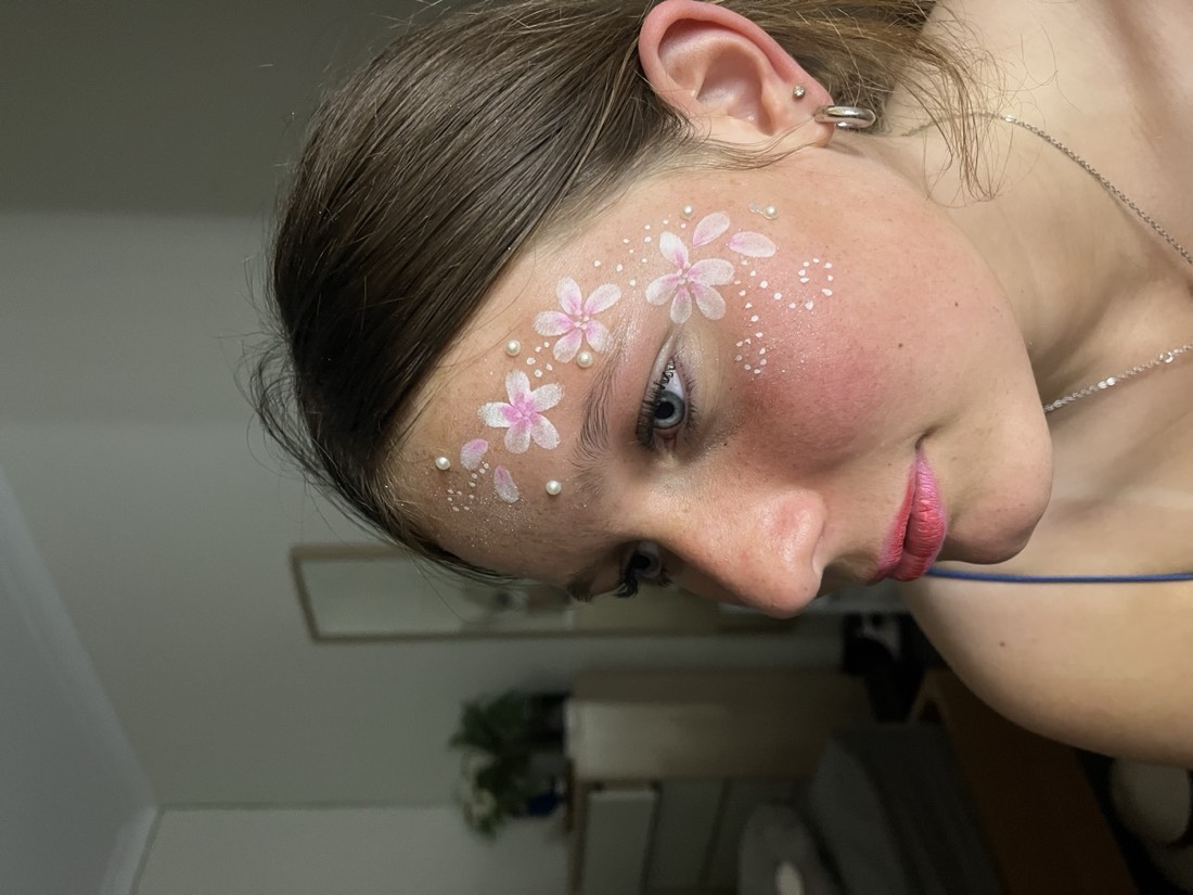 Blossom face paint design with pearls and glitter
