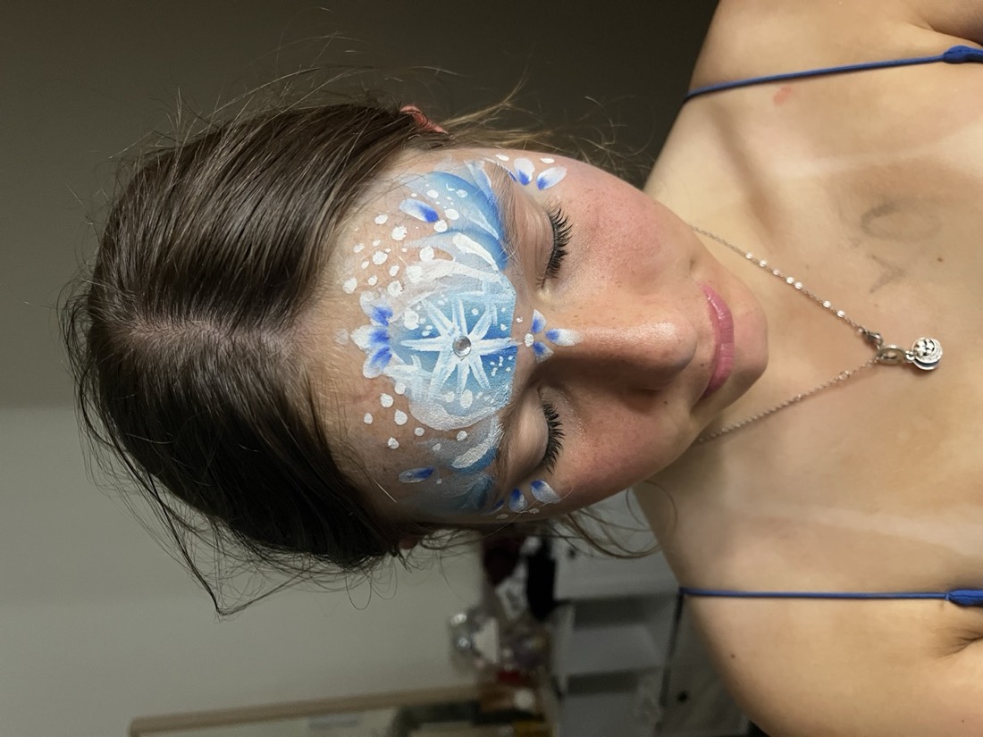 Ice snowflake face paint design in blue and white