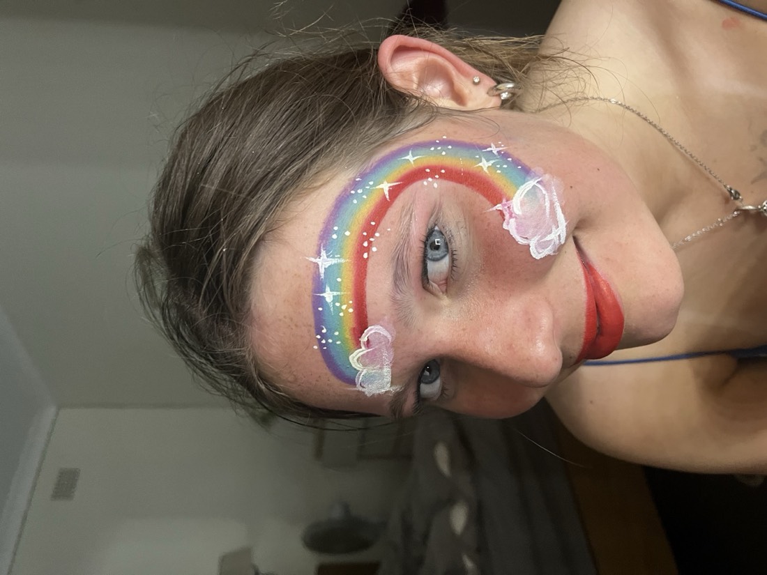 Rainbow and clouds face paint design