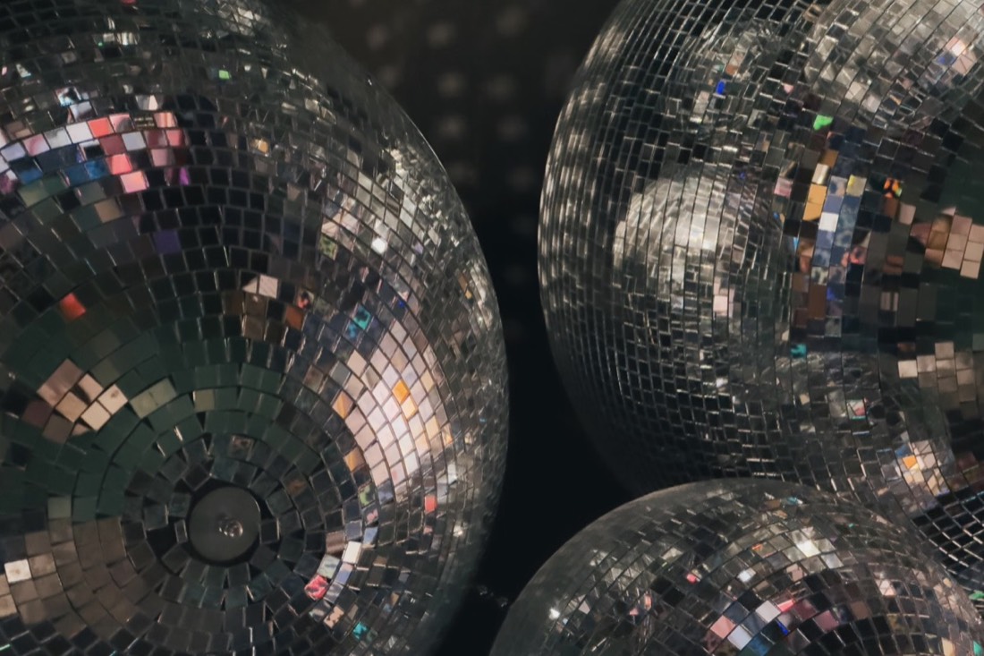 Mirrored disco balls catching the light at a Polished Parties disco