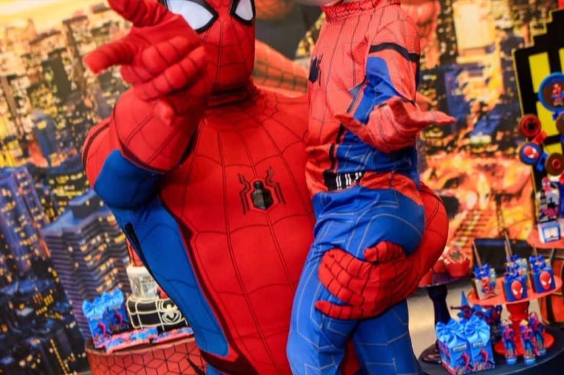 A Polished Parties spider hero entertainer with a child at a themed party